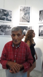 Mehmet Şik in front of the photos honouring him