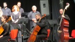 members of the orchestra with Cahit Kutrafalı (contrabass), one of the composers